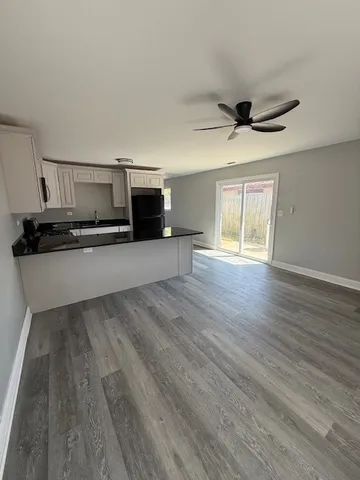 a kitchen with granite countertop a stove and a microwave