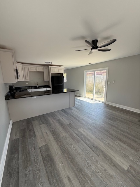 2421 B Lewis Avenue, Unit 2421B Zion, IL 60099 - Photo 2 of 8 a kitchen with granite countertop a stove and a microwave