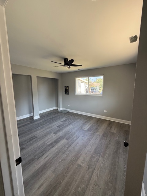 2421 B Lewis Avenue, Unit 2421B Zion, IL 60099 - Photo 5 of 8 a view of an empty room with wooden floor and a window