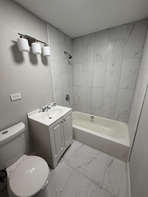 2421 B Lewis Avenue, Unit 2421B Zion, IL 60099 - Photo 6 of 8 a bathroom with a sink a toilet and bathtub
