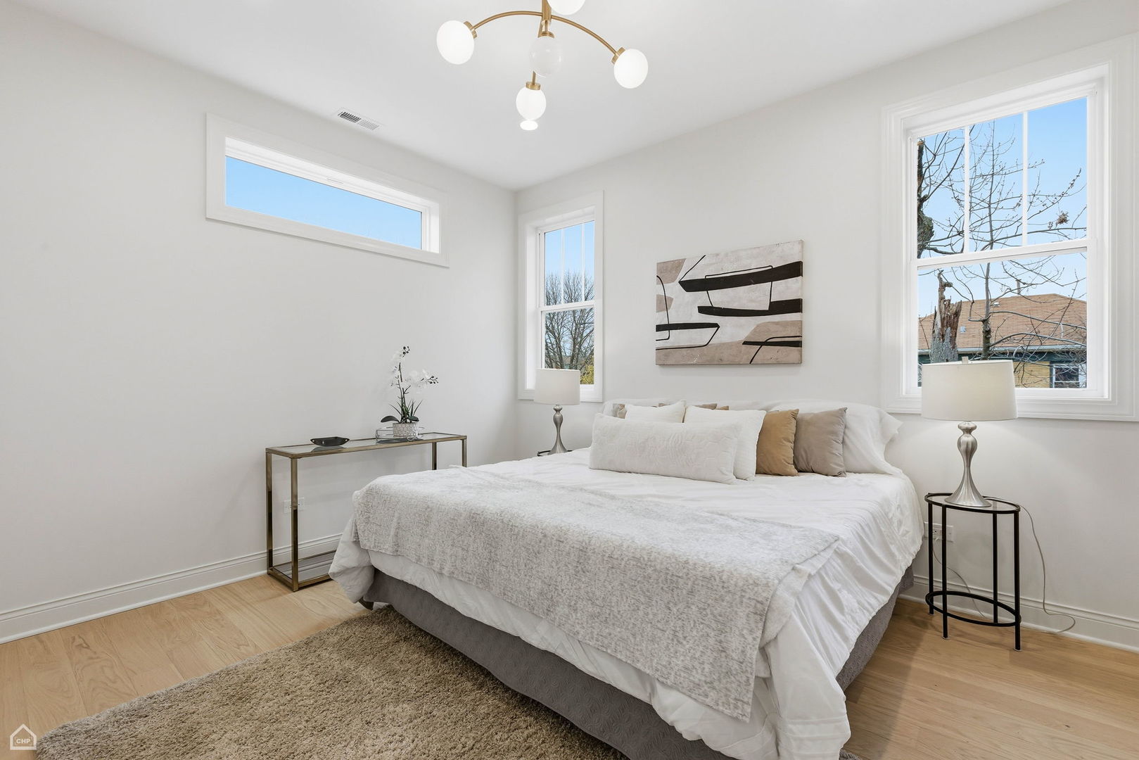 Undisclosed Address Chicago, IL 60625 - Photo 21 of 36 a bedroom with a bed a dresser and next to a window