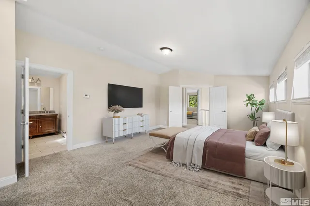 a bedroom with furniture and a flat screen tv