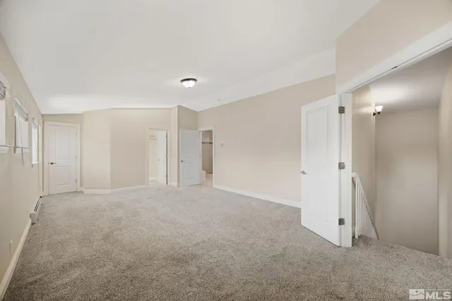 an empty room with an entrance to other room