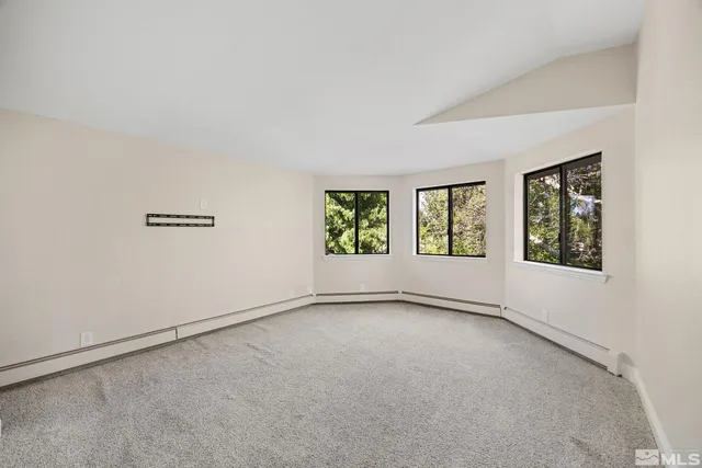 a view of a living room with furniture and a window