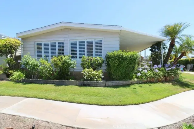 a front view of a house with a garden