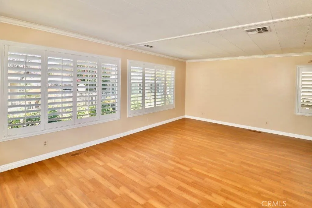 16901 Pleasant Way, Unit 231 Yorba Linda, CA 92886 - Photo 17 of 43 a view of an empty room with a window and wooden floor
