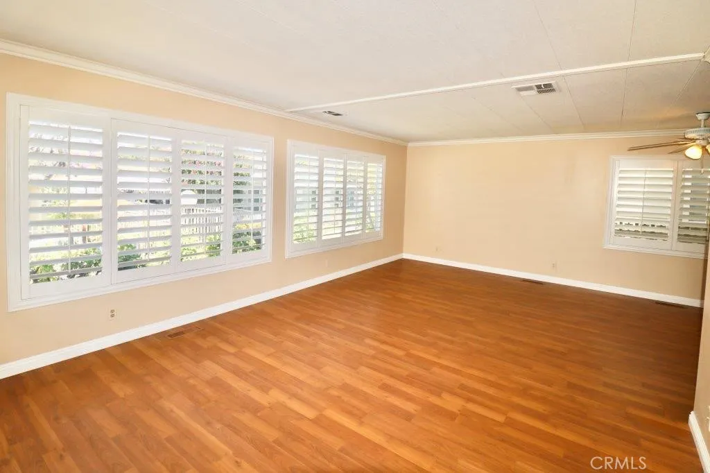16901 Pleasant Way, Unit 231 Yorba Linda, CA 92886 - Photo 18 of 43 a view of an empty room with wooden floor and a window