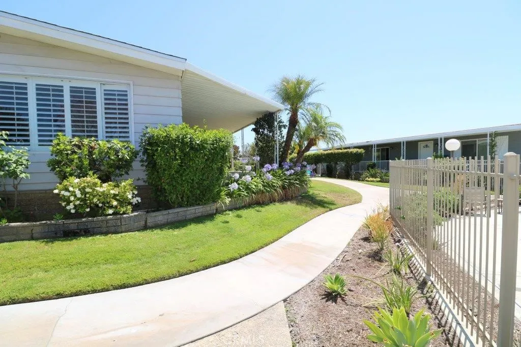 16901 Pleasant Way, Unit 231 Yorba Linda, CA 92886 - Photo 2 of 43 a view of a house with a yard and potted plants