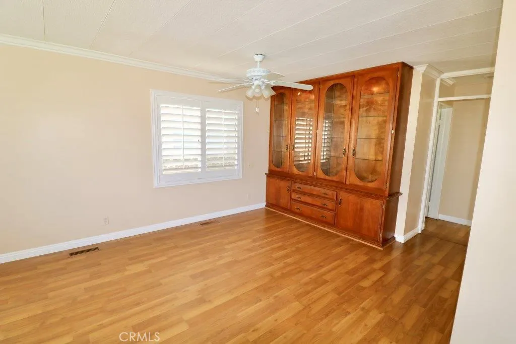 16901 Pleasant Way, Unit 231 Yorba Linda, CA 92886 - Photo 21 of 43 a view of an empty room with wooden floor and a window