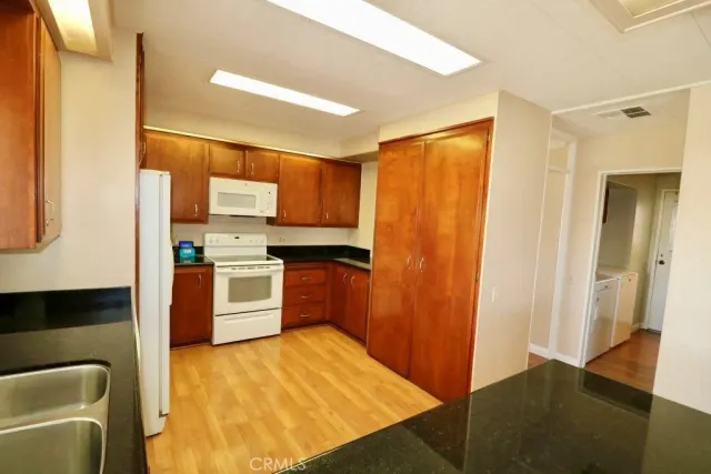 a kitchen with a refrigerator sink and cabinets