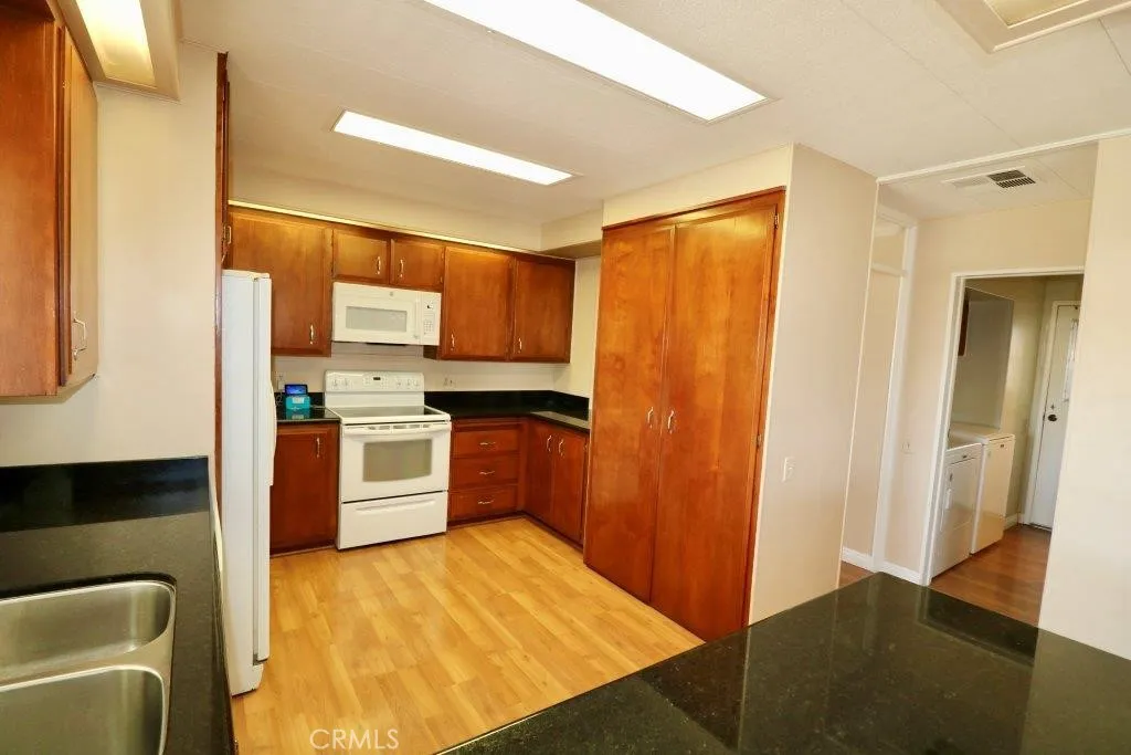 16901 Pleasant Way, Unit 231 Yorba Linda, CA 92886 - Photo 22 of 43 a kitchen with a refrigerator sink and cabinets