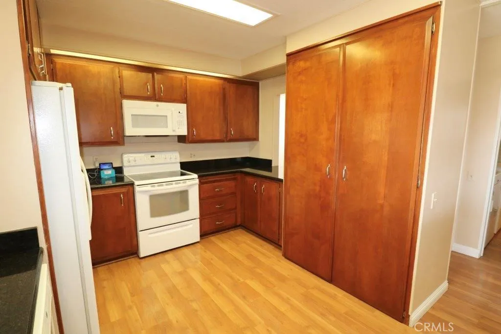 16901 Pleasant Way, Unit 231 Yorba Linda, CA 92886 - Photo 26 of 43 a kitchen with a sink a stove a refrigerator and cabinets