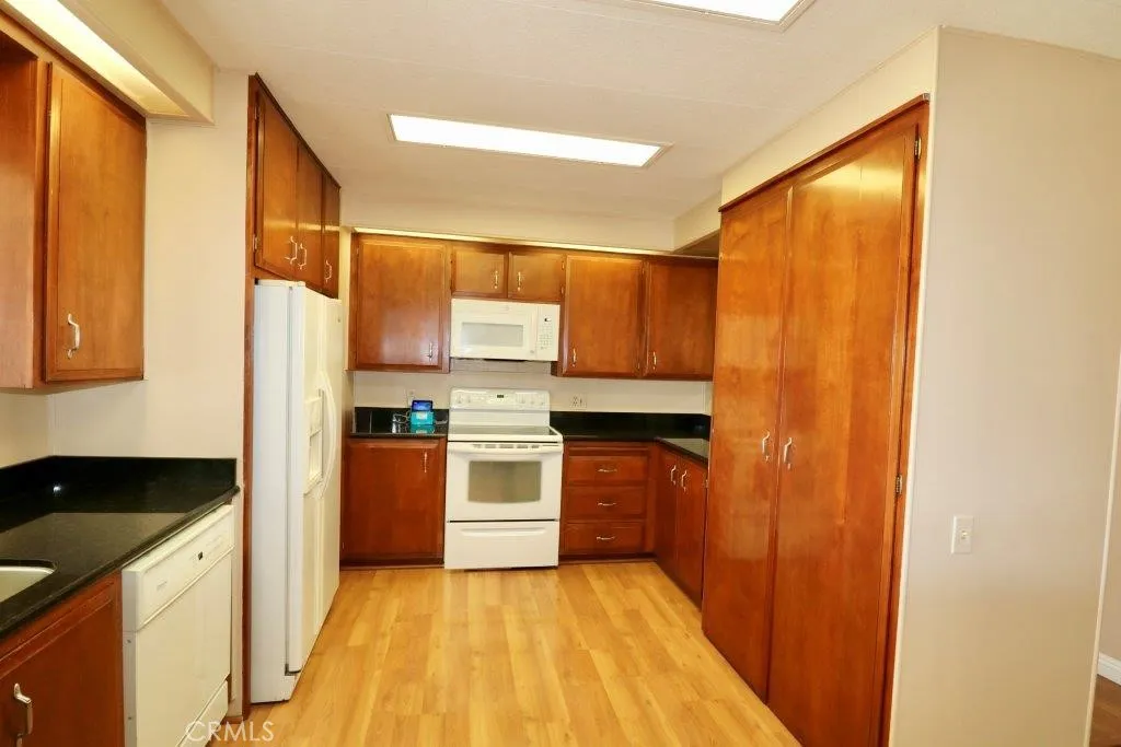 16901 Pleasant Way, Unit 231 Yorba Linda, CA 92886 - Photo 27 of 43 a kitchen with a refrigerator and a sink