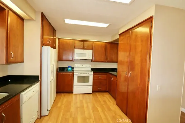 a kitchen with a refrigerator and a sink