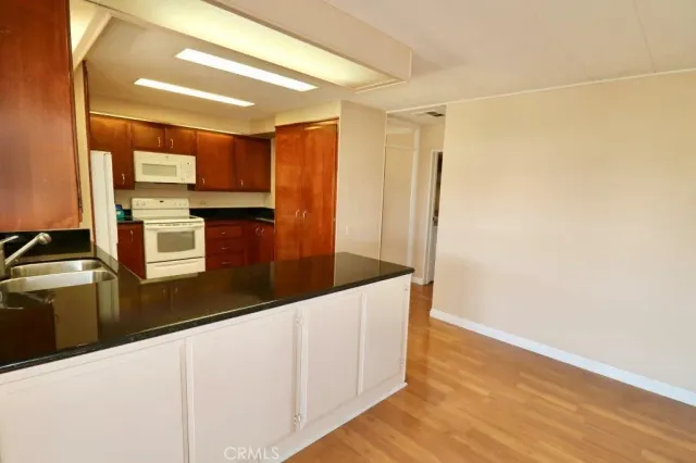 a kitchen with stainless steel appliances a refrigerator and a stove