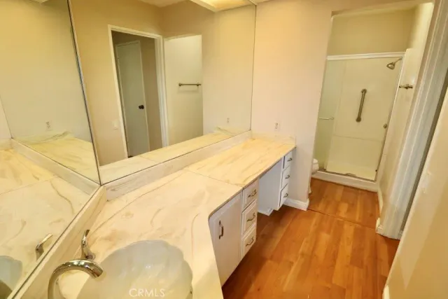 a bathroom with a tub sink and mirror