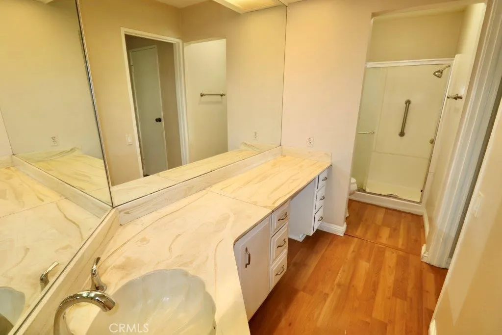 16901 Pleasant Way, Unit 231 Yorba Linda, CA 92886 - Photo 35 of 43 a spacious bathroom with a granite countertop sink and a mirror