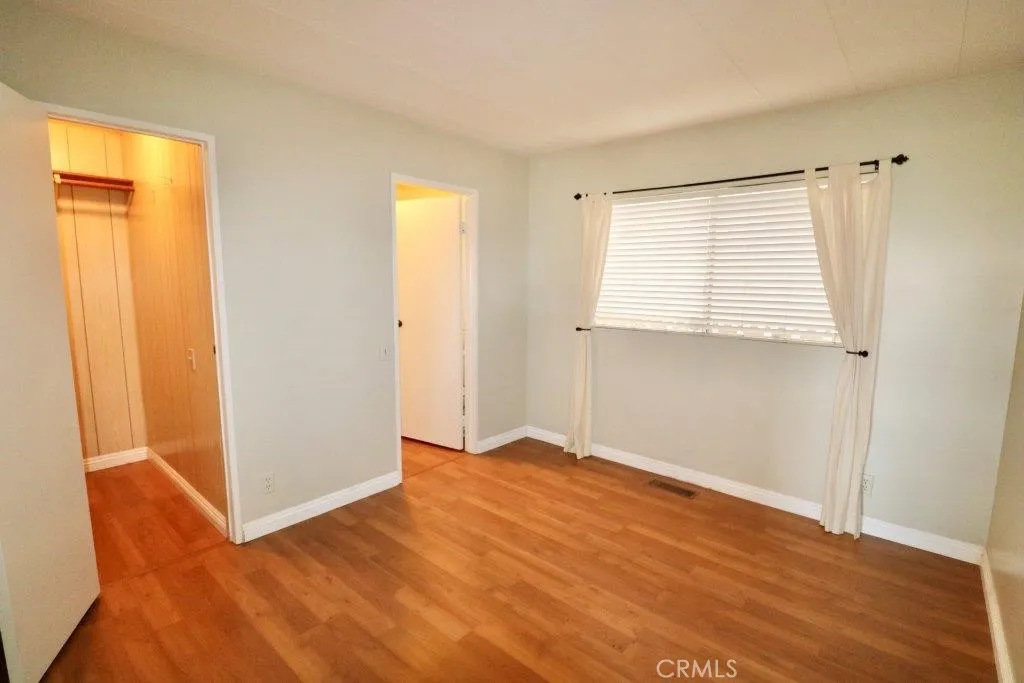 16901 Pleasant Way, Unit 231 Yorba Linda, CA 92886 - Photo 39 of 43 a view of an empty room with wooden floor and a window