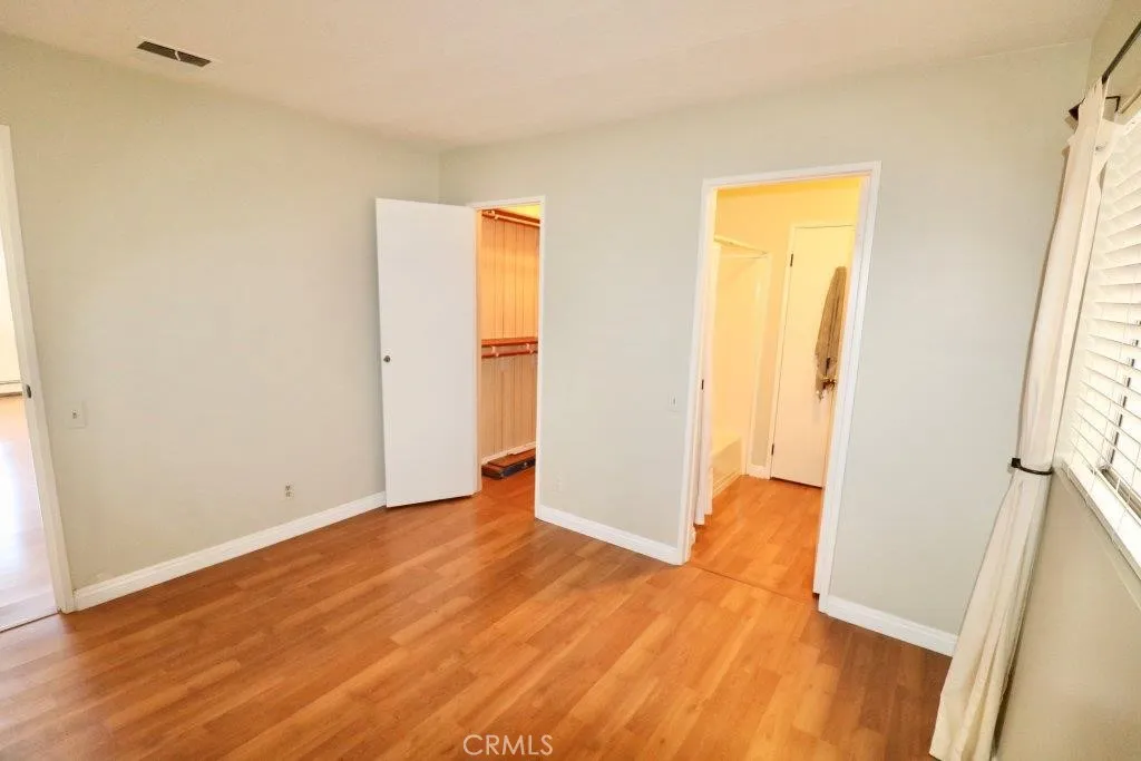 16901 Pleasant Way, Unit 231 Yorba Linda, CA 92886 - Photo 40 of 43 a view of an empty room with wooden floor and a window