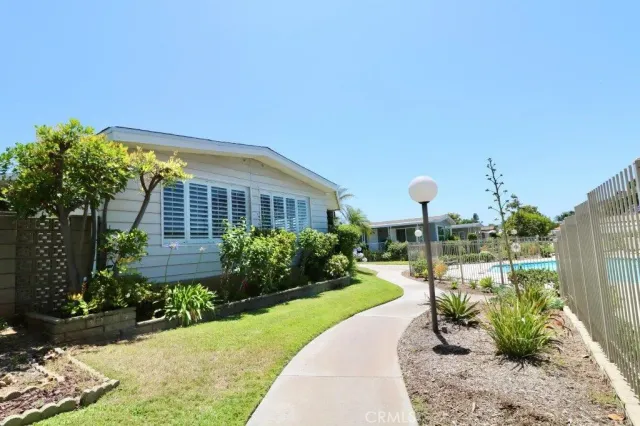 a view of a garden with a building in the background
