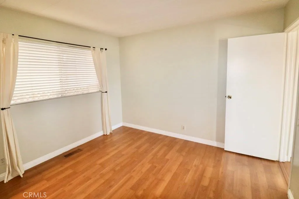 16901 Pleasant Way, Unit 231 Yorba Linda, CA 92886 - Photo 41 of 43 a view of an empty room with wooden floor and a window
