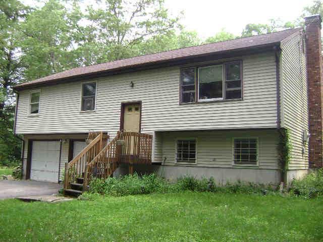 205 Old Monson Road Stafford, CT 06076 - Photo 1 of 1 a front view of a house with a yard