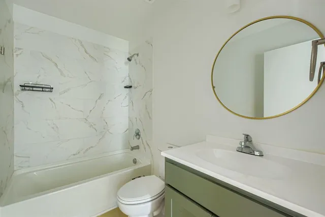 a bathroom with a sink a toilet and a mirror