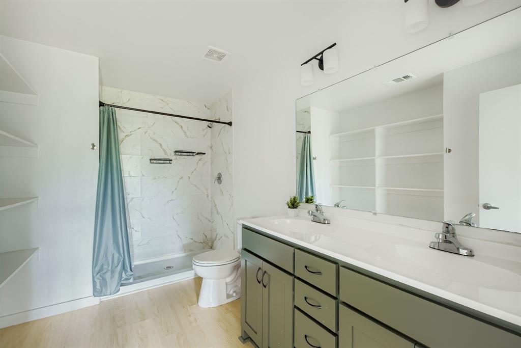 304 Thomas Street Terrell, TX 75160 - Photo 10 of 12 a bathroom with a sink and a mirror