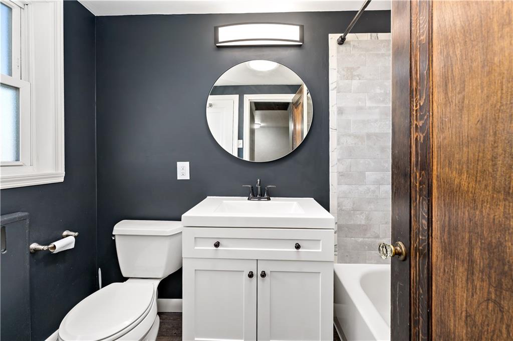 425 MacArthur Street McKees Rocks, PA 15136 - Photo 17 of 25 a bathroom with a sink a toilet and a mirror