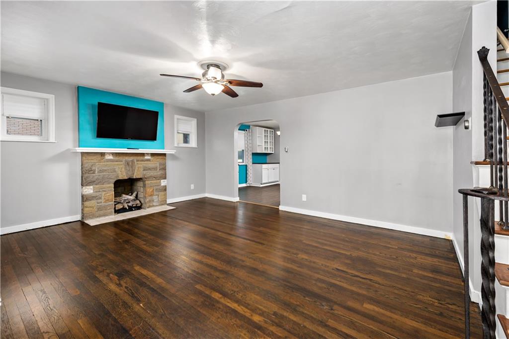 425 MacArthur Street McKees Rocks, PA 15136 - Photo 2 of 25 a view of an empty room with wooden floor fireplace and a window