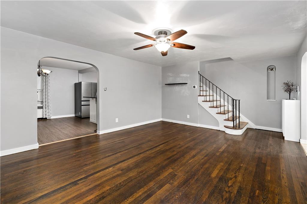 425 MacArthur Street McKees Rocks, PA 15136 - Photo 4 of 25 a view of an empty room with wooden floor and a ceiling fan