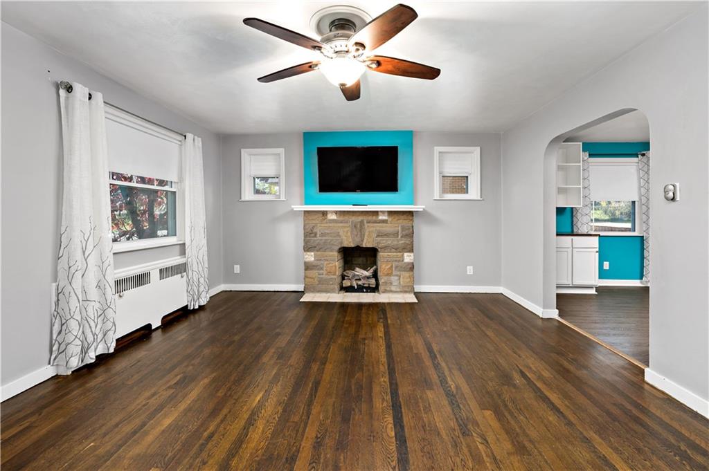 425 MacArthur Street McKees Rocks, PA 15136 - Photo 5 of 25 a living room with wooden floor and a fireplace