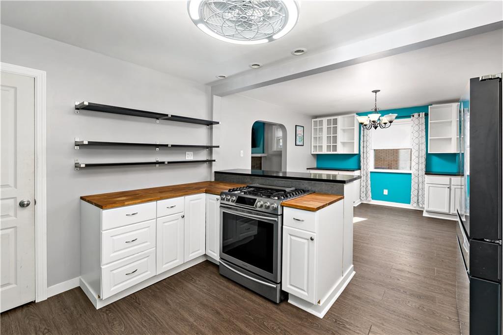 425 MacArthur Street McKees Rocks, PA 15136 - Photo 9 of 25 a kitchen with a stove and a wooden floor
