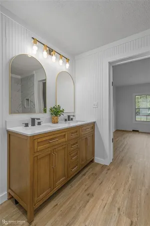 a spacious bathroom with a double vanity sink and a mirror