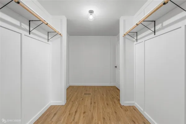 a view of a room with wooden floor and white walls