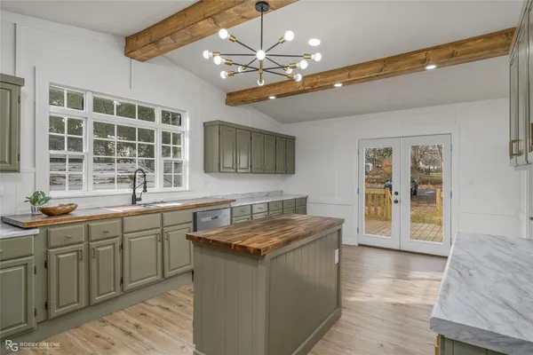 a kitchen with stainless steel appliances granite countertop a sink and dishwasher with wooden floor