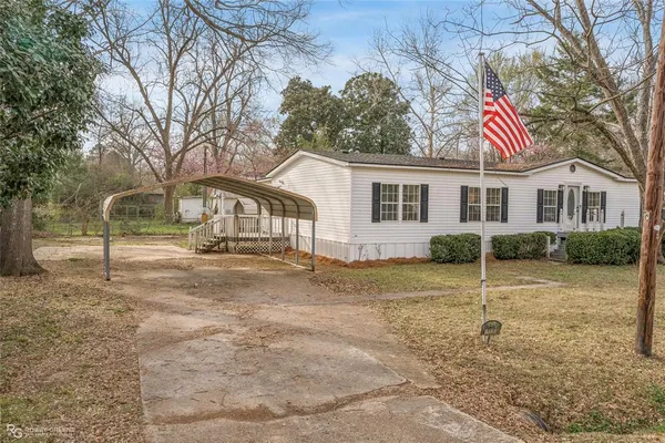 a view of a white house with a yard