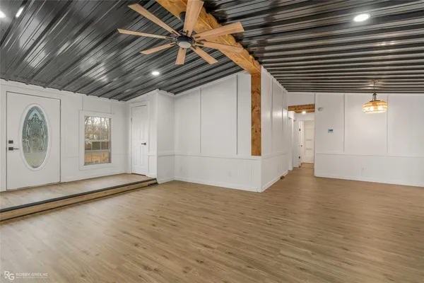a view of an empty room with wooden floor