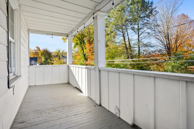 a view of balcony with wooden floor and fence