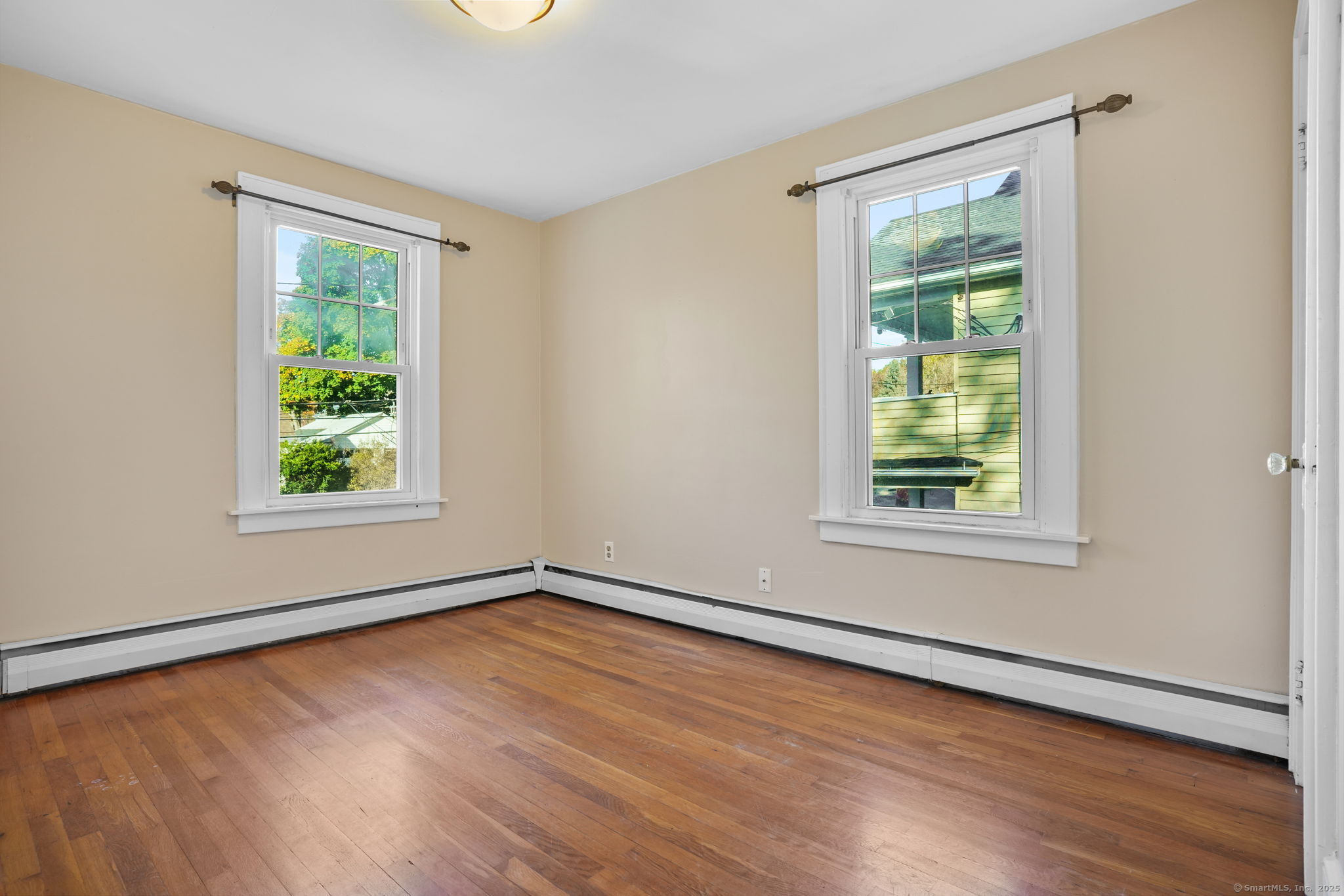 117 Golden Hill Street Naugatuck, CT 06770 - Photo 5 of 10 a view of an empty room with wooden floor and a window