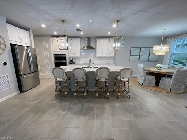 a large kitchen with a table and chairs
