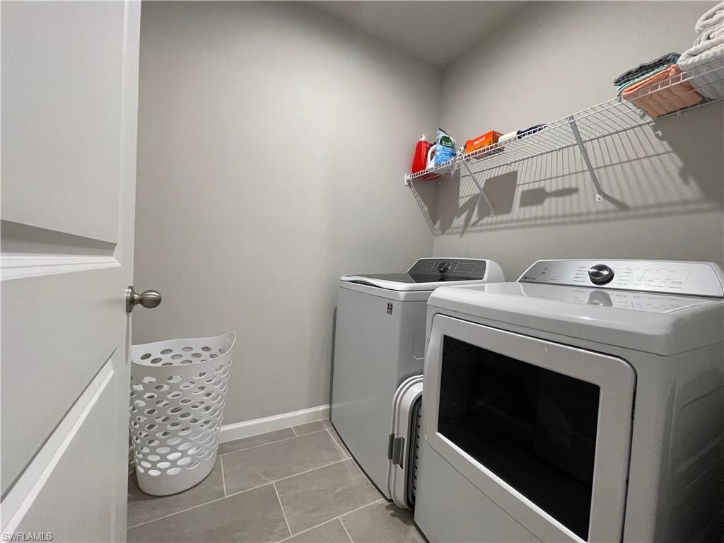 4676 Arboretum Circle, Unit 101 Naples, FL 34112 - Photo 21 of 24 a utility room with dryer and washer