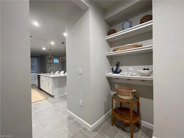 a room with table chair and appliances