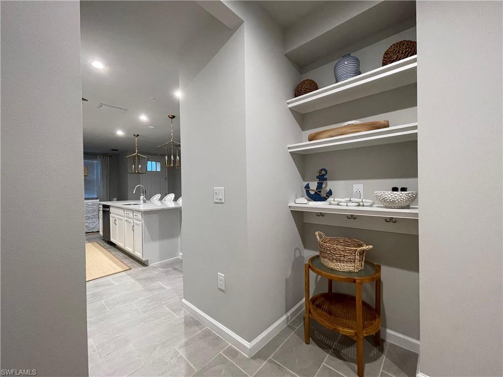 4676 Arboretum Circle, Unit 101 Naples, FL 34112 - Photo 23 of 24 a room with table chair and appliances