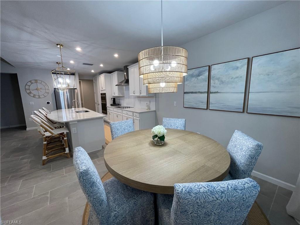 4676 Arboretum Circle, Unit 101 Naples, FL 34112 - Photo 3 of 24 a view of a dining room with furniture