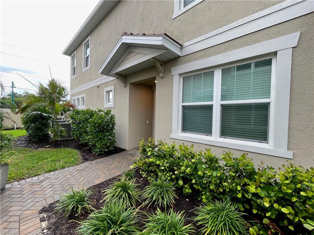 4676 Arboretum Circle, Unit 101 Naples, FL 34112 - Photo 7 of 24 a house with a small garden area