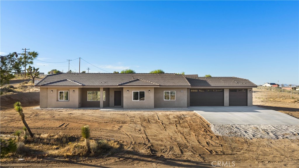 22324 Rancho Street Apple Valley, CA 92308 - Photo 1 of 47 a front view of a house with a yard