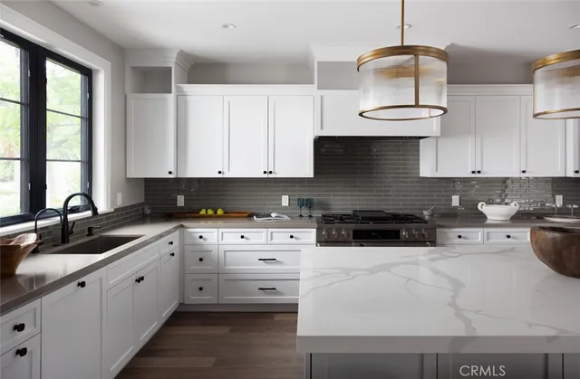 a kitchen with granite countertop white cabinets and white appliances