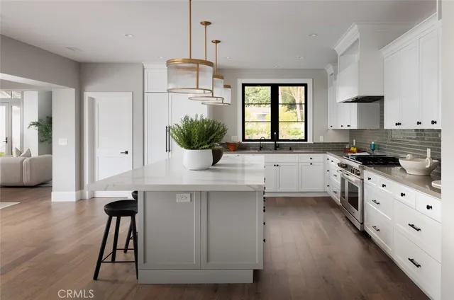 a kitchen with center island table and chairs