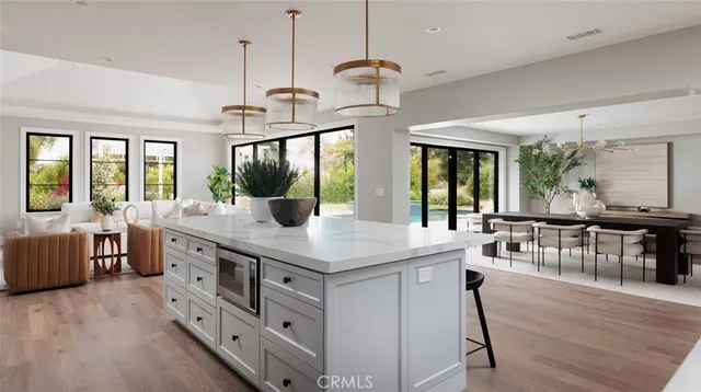 a living room with fireplace furniture and a large window